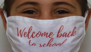 Photo Of girl wearing mask that says "welcome back to school"